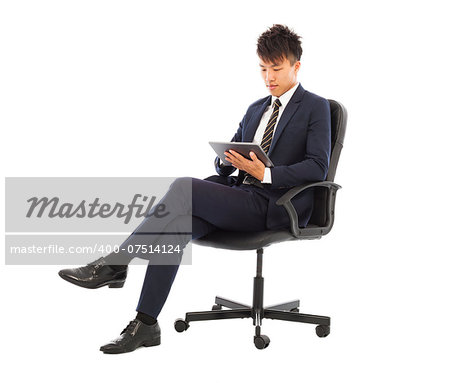 businessman using tablet pc on the chair