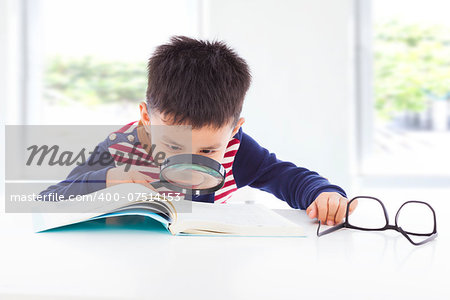 little boy detective searching clues from books