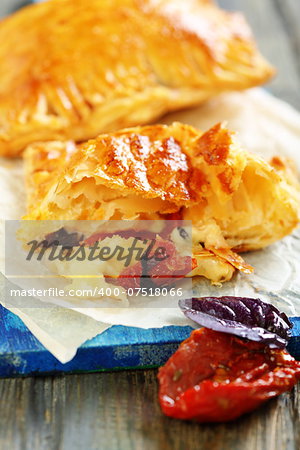 Puff pastry with cheese, sun-dried tomatoes with basil.