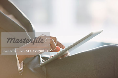 Businesswoman using digital tablet, close up