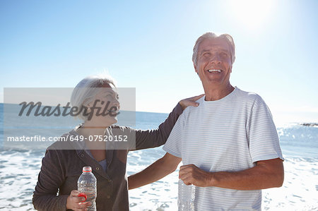 Portrait of happy couple by seaside