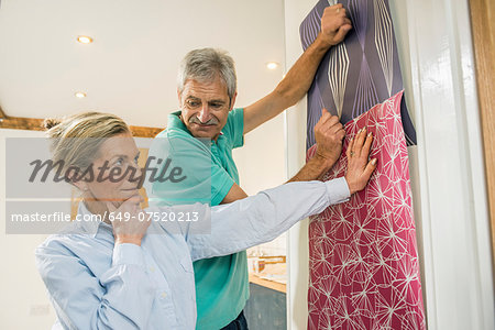 Senior couple making decision on wallpaper