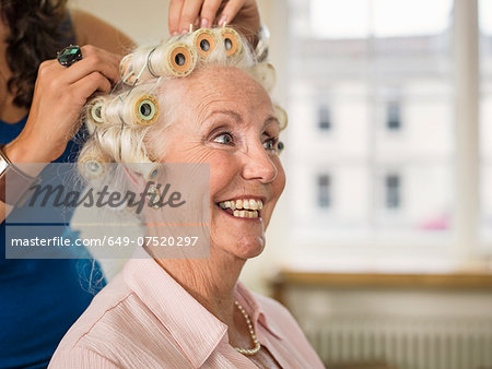 Senior woman with rollers at hairdressers