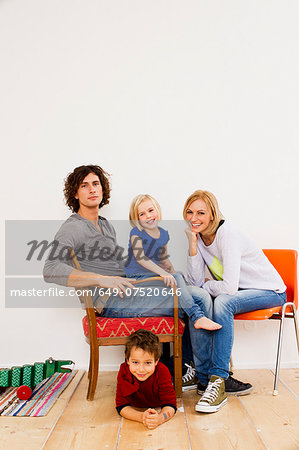 Studio portrait of couple sitting with son and daughter