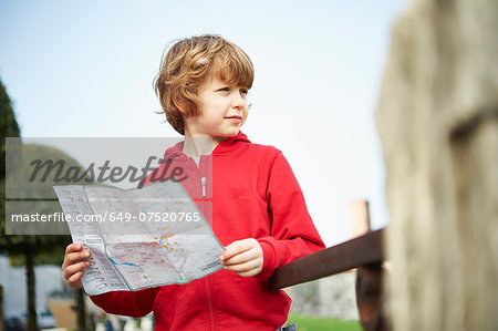 Young boy holding map in park, Province of Venice, Italy