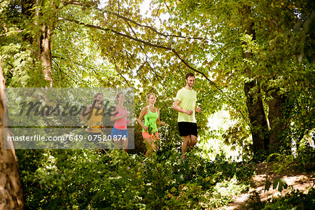 Group of runners running in woods
