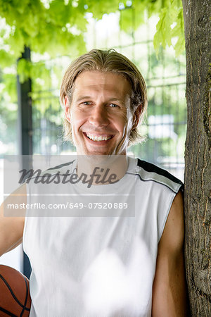 Portrait of male basketball player in park