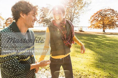 Couple laughing in sunlight in park