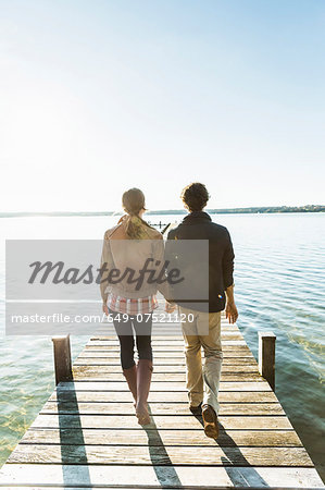 Couple on jetty, Lake Starnberg, Bavaria, Germany