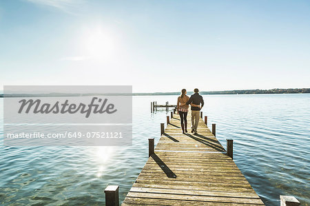 Couple on jetty, Lake Starnberg, Bavaria, Germany