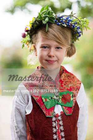 Girl in national costume wearing flower wreath, Sandham, Sweden