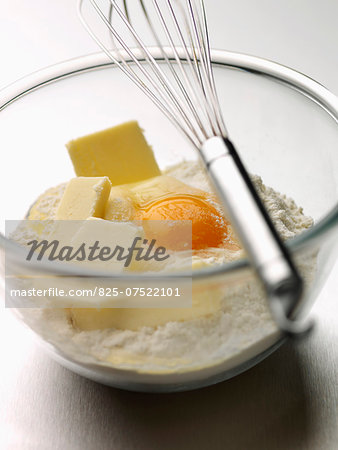 Mixing the flour,butter and whole egg in a bowl with a whisk
