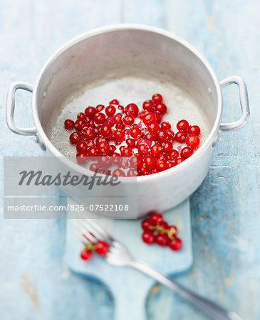 Cooking the redcurrants with sugar and water over a brisk heat