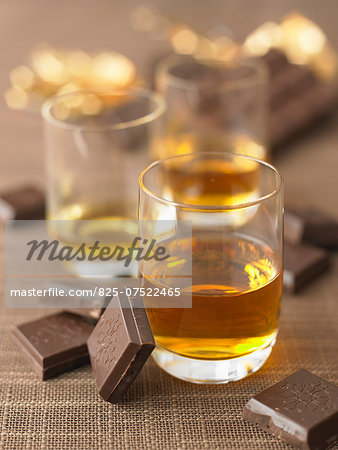Glassses of liqueur and squares of chocolate