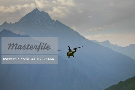 Helicopter flies through valleys of Karokoram Mountains, Skardu Valley, North Pakistan