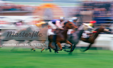 Soft focus horseracing action at Epsom Races in Surrey, United Kingdom on the famous Derby Day