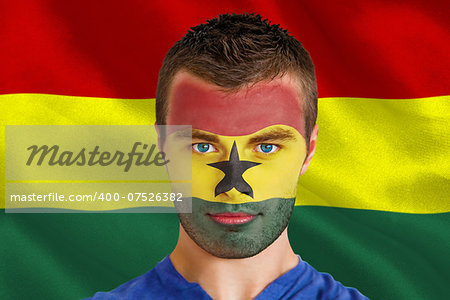 Composite image of serious young ghana fan with facepaint against digitally generated ghana national flag