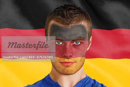 Composite image of serious young belgium fan with facepaint against digitally generated german national flag