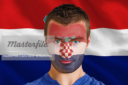 Composite image of serious young croatia fan with facepaint against digitally generated croatia national flag