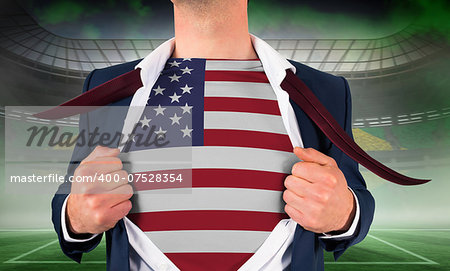 Businessman opening shirt to reveal usa flag against vast football stadium for world cup