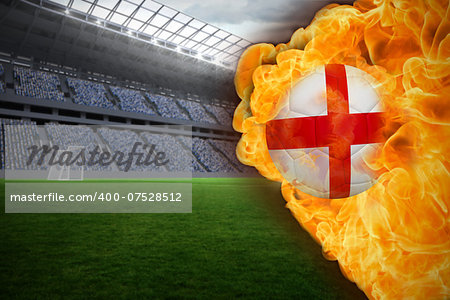 Composite image of fire surrounding england flag football against vast football stadium with fans in blue