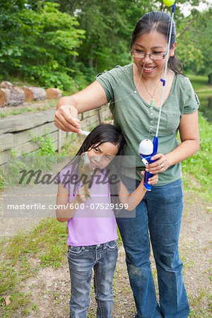 Mother and Daughter Showing off Freshly Caught Fish, Lake Fairfax, Reston, Virginia, USA