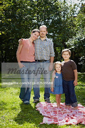 Family Standing In Garden, Munich, Bavaria, Germany