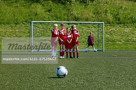 Boys at soccer training, ball in foreground, Munich, Bavaria, Germany