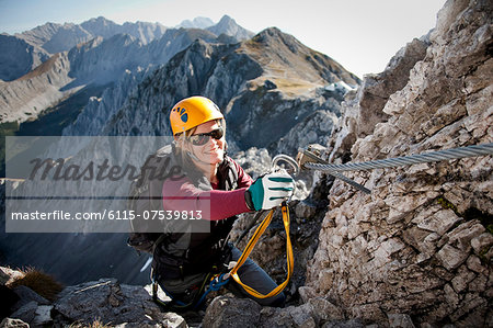 Female alpinist rock climbing, Innsbruck route, Tyrol, Austria