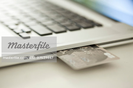 Credit card sticking out of side of laptop computer