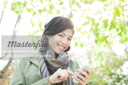 Young woman using smartphone outdoors