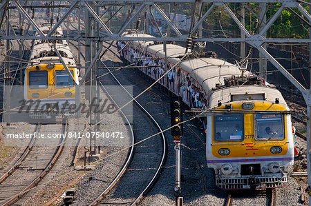 Office workers on crowded commuter train of Western Railway near Mahalaxmi Station on the Mumbai Suburban Railway, India