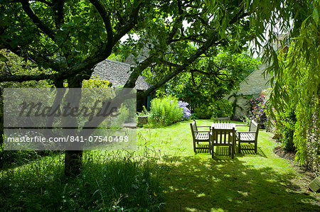 English cottage garden in Swinbrook in The Cotswolds, Oxfordshire, UK English cottage garden in Swinbrook in The Cotswolds, Oxfordshire, UK
