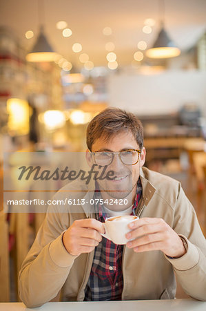 Man drinking coffee in cafe