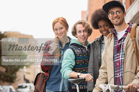 Friends smiling together on city street