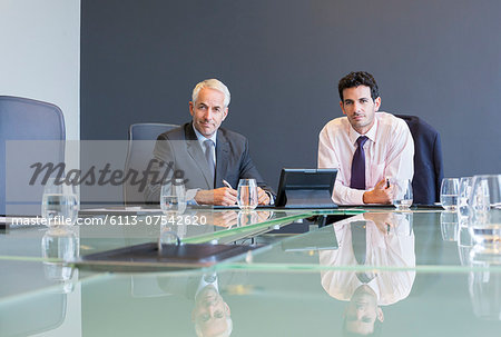 Businessmen using digital tablet in meeting