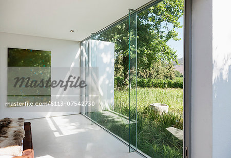 Modern house with glass walls overlooking grass Modern house with glass walls overlooking grass