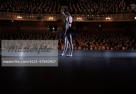 Ballet dancer performing on stage in theater