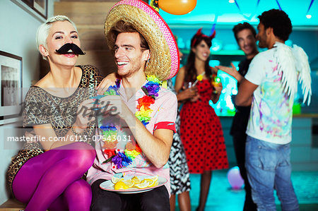 Couple wearing costumes at party Couple wearing costumes at party