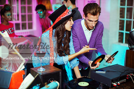 Couple playing records at party