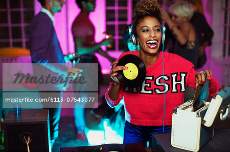 Woman playing records at party Woman playing records at party
