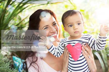 Mother holding baby girl outdoors