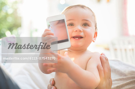 Baby boy playing with cell phone Baby boy playing with cell phone