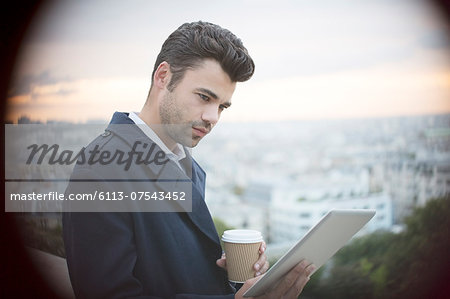 Businessman using digital tablet overlooking Paris, France