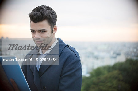 Businessman using digital tablet outdoors