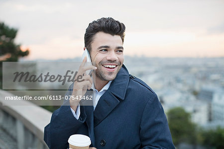 Businessman on cell phone outdoors