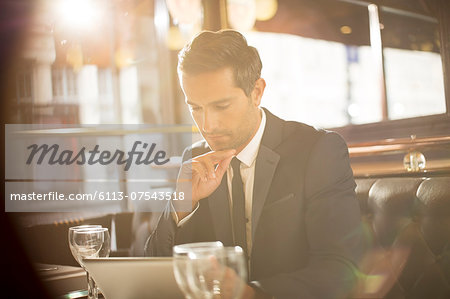 Businessman using digital tablet in restaurant