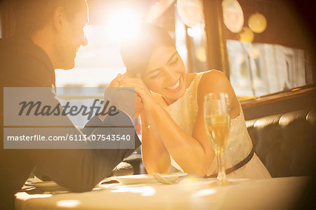 Couple holding hands in restaurant