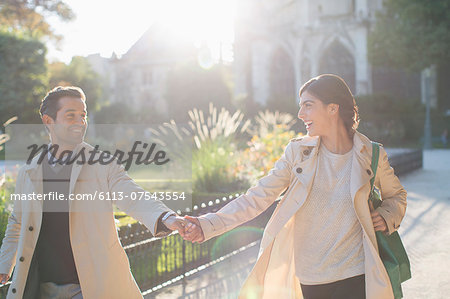 Couple holding hands in urban park