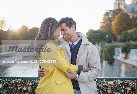 Couple hugging on Pont des Arts, Paris, France